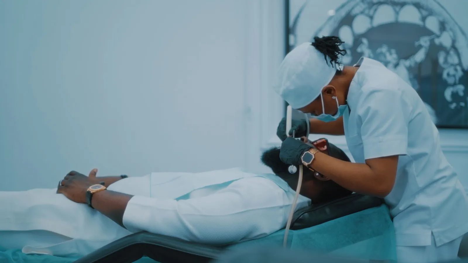 A dental professional performs a procedure on a patient in a Lagos clinic.